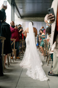 Vibrant Same Sex Lesbian Wedding, Bride Wearing Lace Wedding Dress Walking Down the Wedding Ceremony Aisle | Tampa Bay Wedding Photographer Dewitt for Love Photography