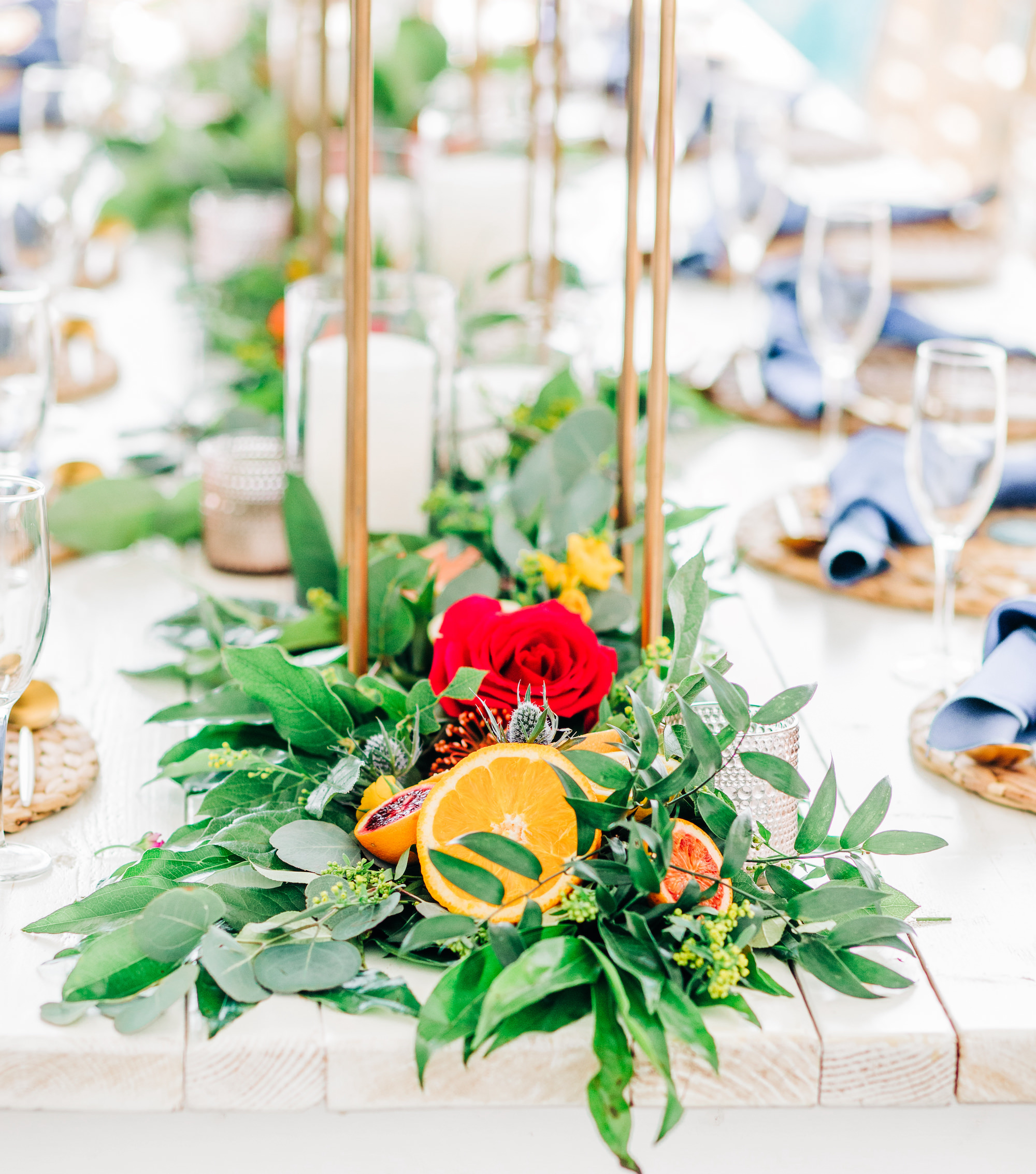 Vibrant Colorful Wedding Reception Decor, Greenery Garland with Sliced Oranges, Blood Oranges and Grapefruit, Red and Yellow Roses | Tampa Bay Wedding Rentals Kate Ryan Event Rentals