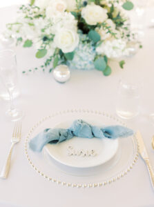White China Wedding Place Settings with Gold Flatware and Baby Blue Napkins | Tampa Rentals Gabro Event Services