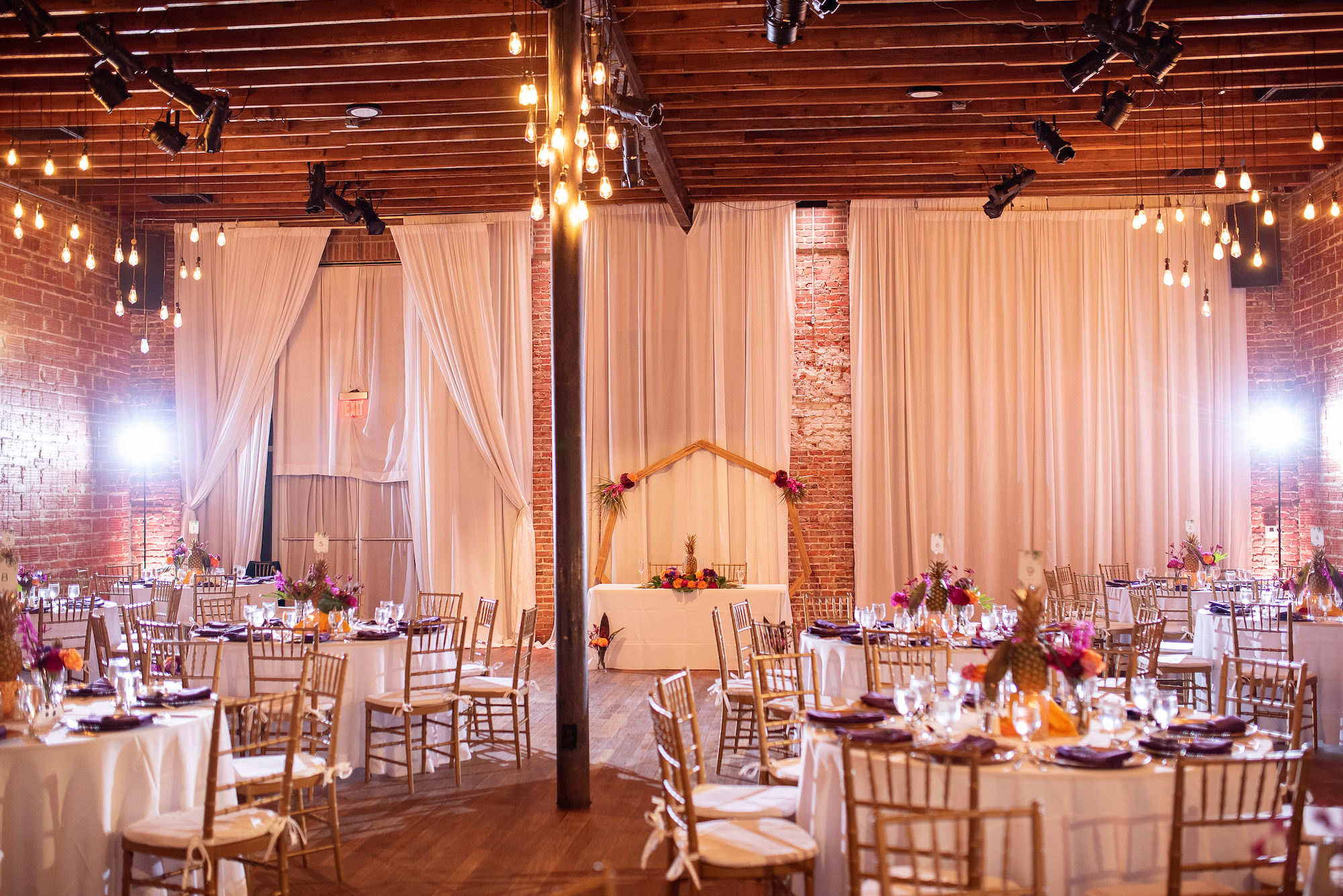 Industrial Indoor Wedding Reception White Linens and Gold Chairs with White Draping | St. Pete Wedding Venue Nova 535