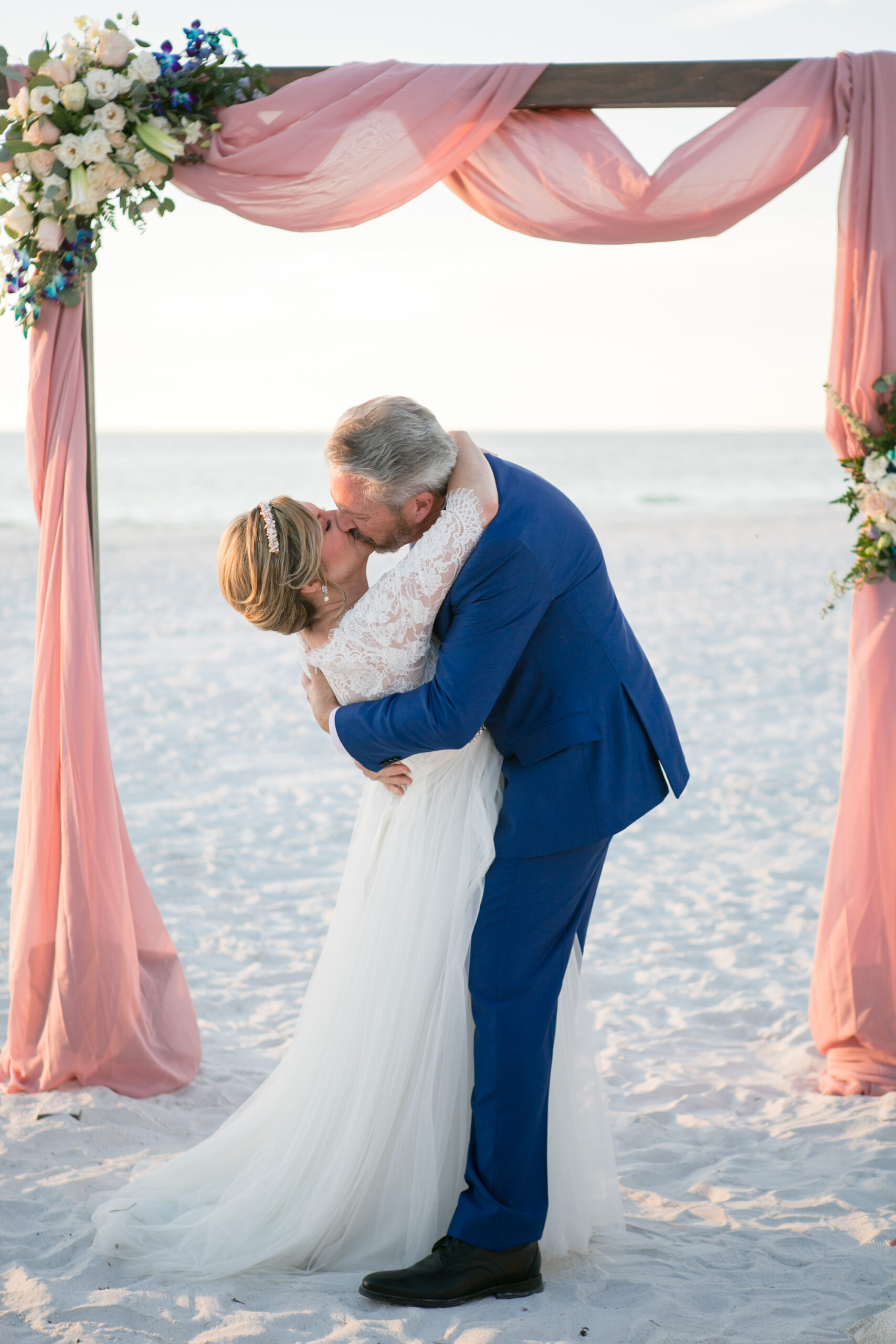 Classic Bride and Groom Kissing on Beach Wedding Ceremony Wedding Portrait | Tampa Bay Wedding Photographer Carrie Wildes Photography
