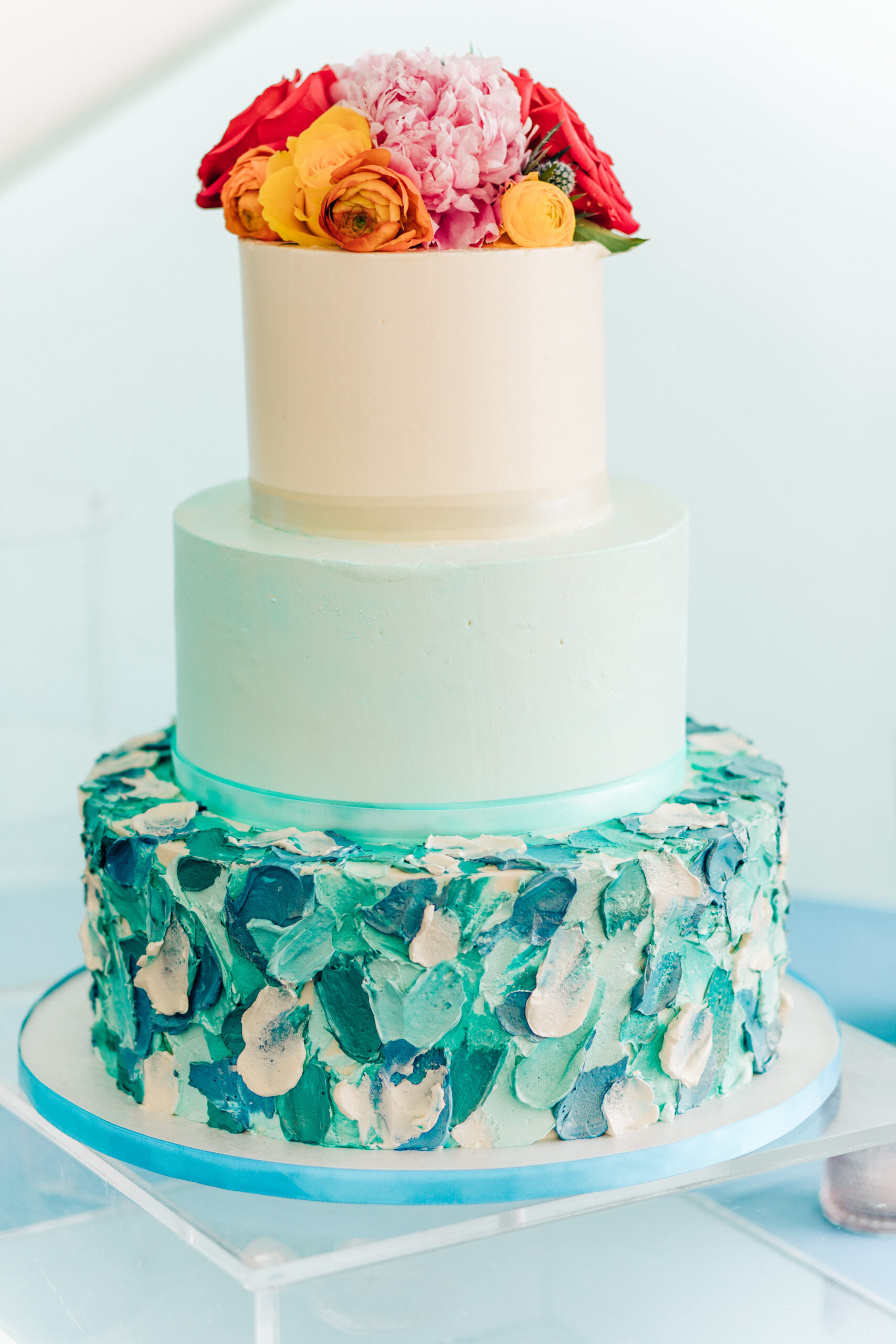 Vibrant Colorful Wedding Reception, Three Tier Blue and White Buttercream Textured Wedding Cake, Yellow and Red Roses with Pink Flower Cake Topper