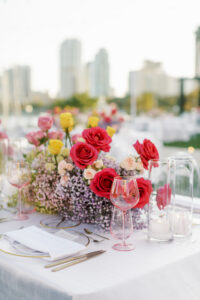 Romantic Spring Whimsical Reception Tablescape Ideas with Ombre Red and Purple Centerpieces with Colorful Roses and Baby's Breath Centerpieces Candles in Cylinder Vases | St. Pete Wedding Florist Bruce Wayne Florals