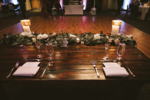 Rustic Wooden Sweetheart Table with Greenery and White Candles