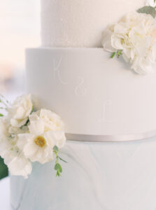 Three Tier White and Pale Blue Wedding Cake with Gold Cake Topper White Floral Details | Tampa Wedding Baker The Artistic Whisk