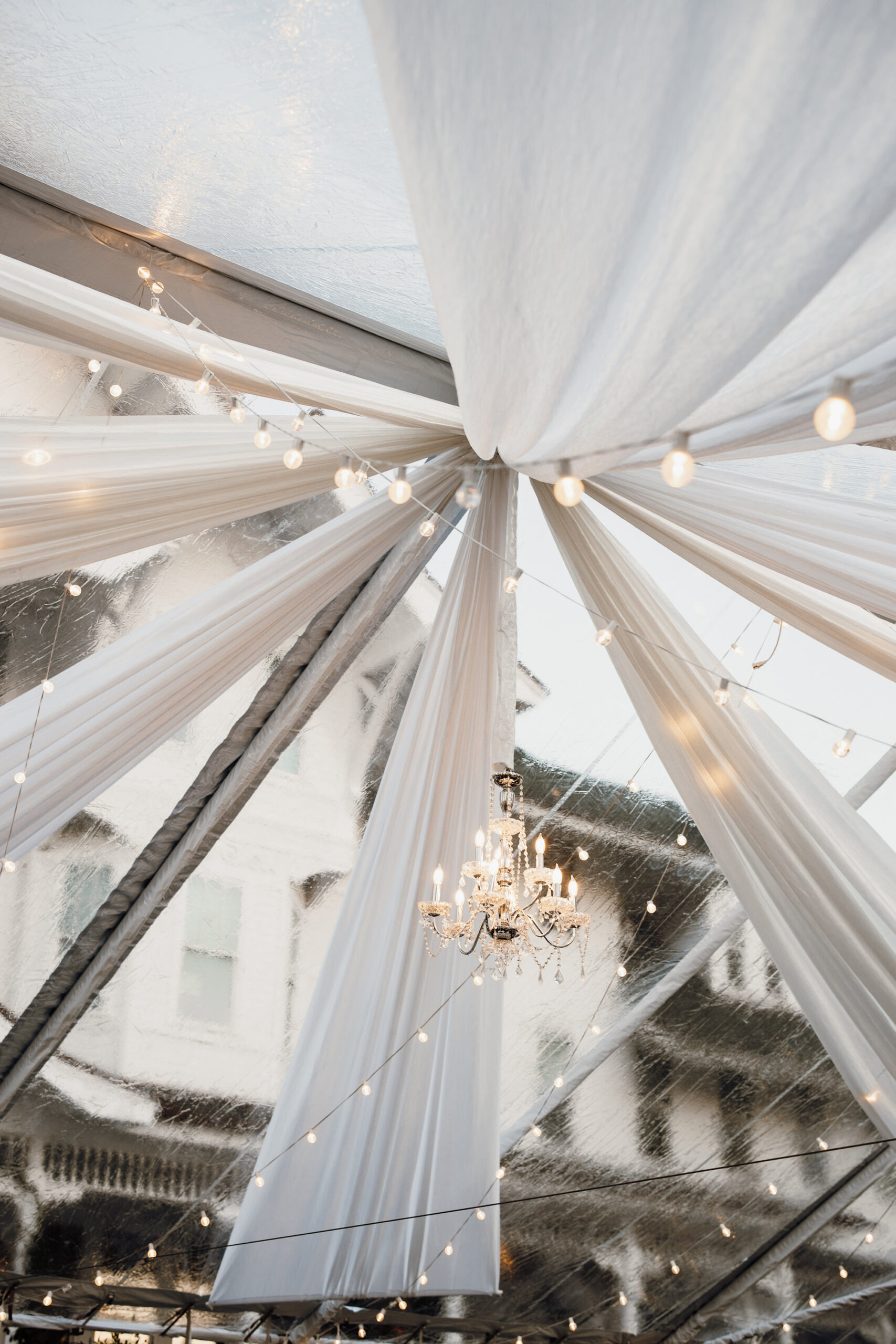Romantic White Tent Draping with Market Lights and Chandelier