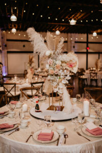 Boho Pampas and Pink and Cream Floral Centerpiece with Wooden Crossback Chairs Wedding Reception | Florida Wedding Venue Haus 820 | Tampa Florida Rentals A Chair Affair