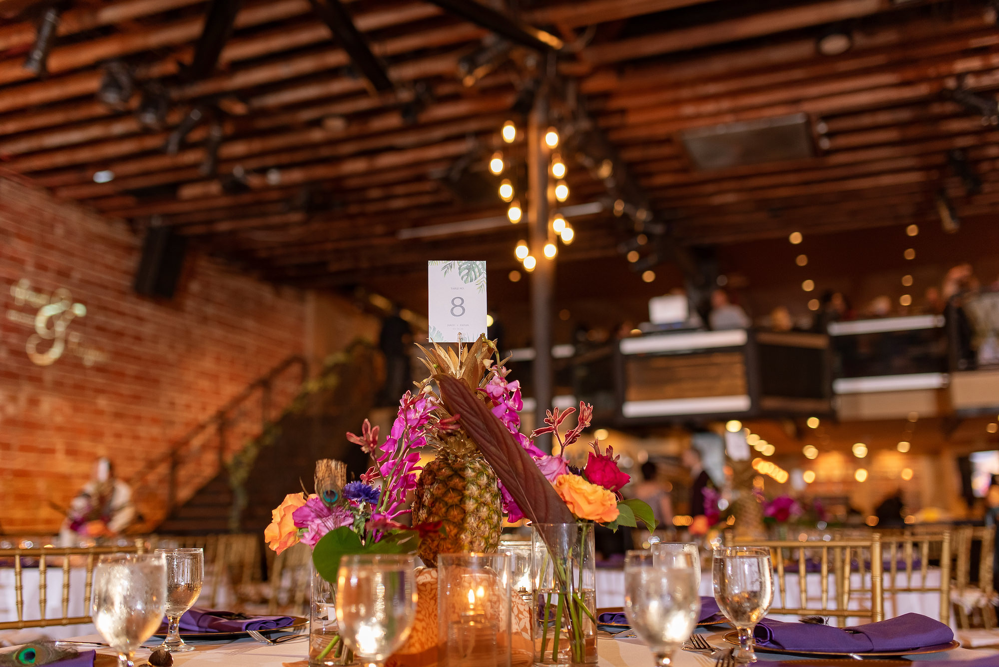 Industrial Indoor Wedding Reception White Linens and Gold Chairs with Tropical Inspired Details and Centerpieces | St. Pete Wedding Venue Nova 535
