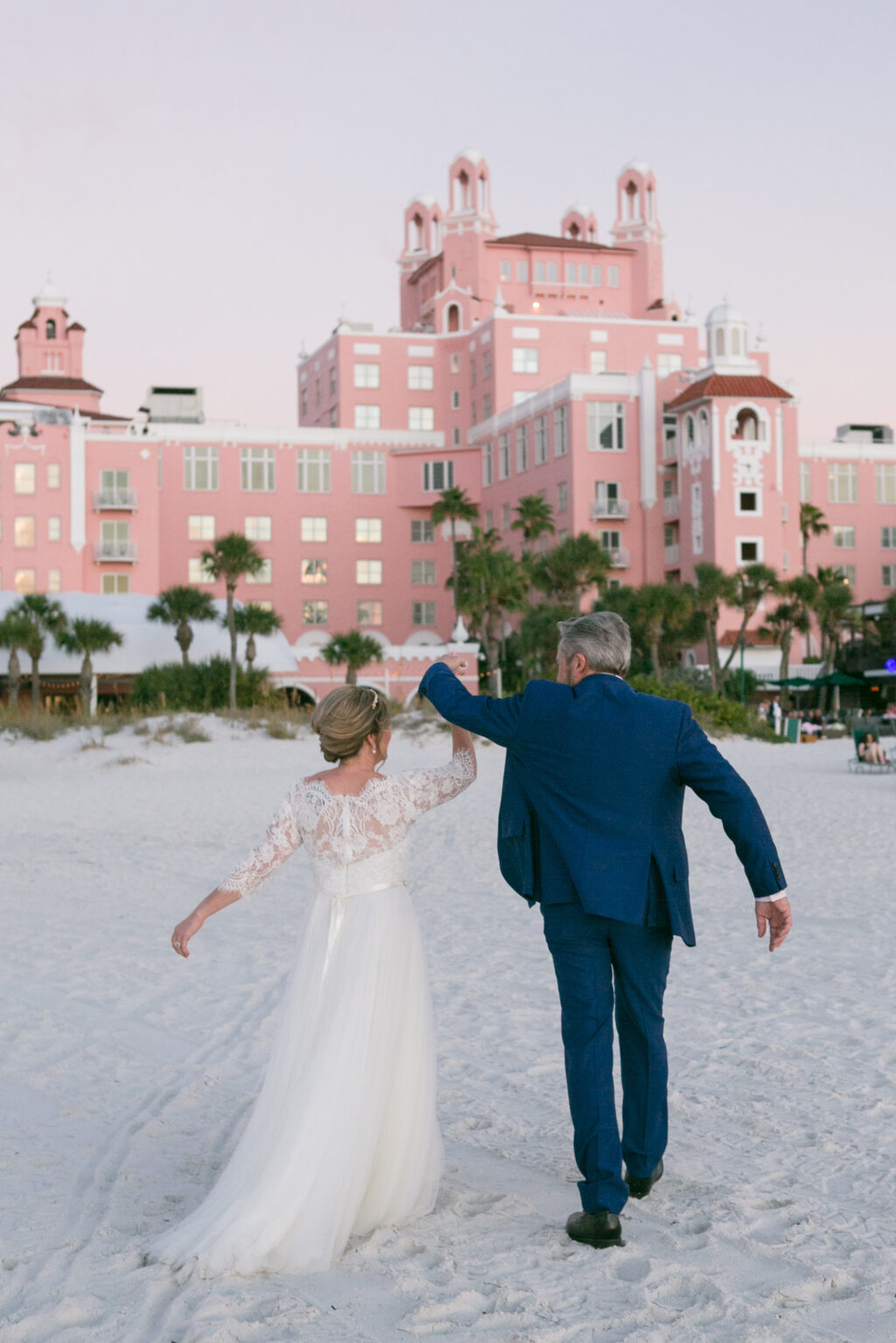 Sunset Classic Bride and Groom on Beach of St. Pete Historic Wedding Venue The Don CeSar, The Pink Palace | Wedding Photographer Carrie Wildes Photography