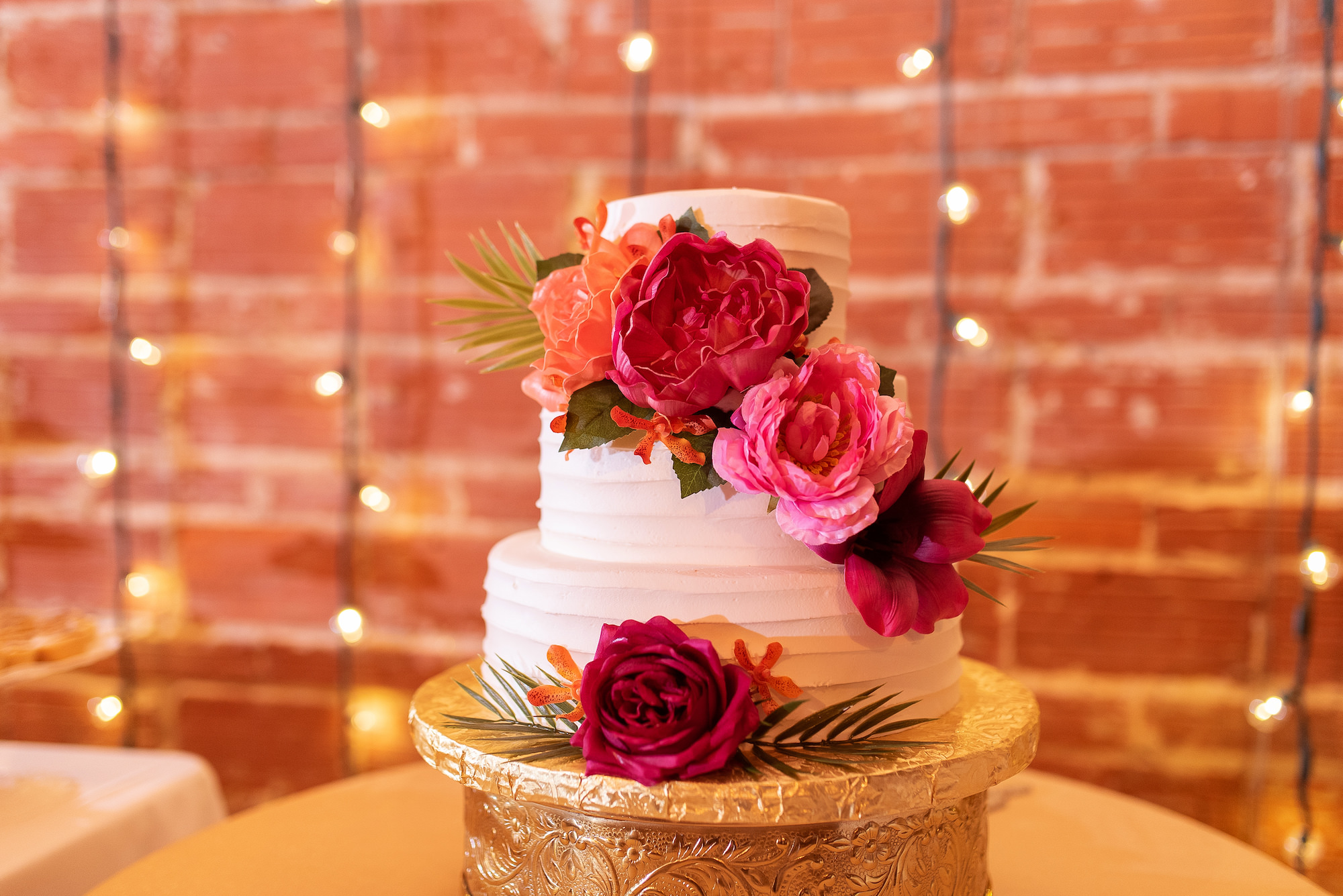 Three Tier White Wedding Cake with Red and Pink Tropical Florals