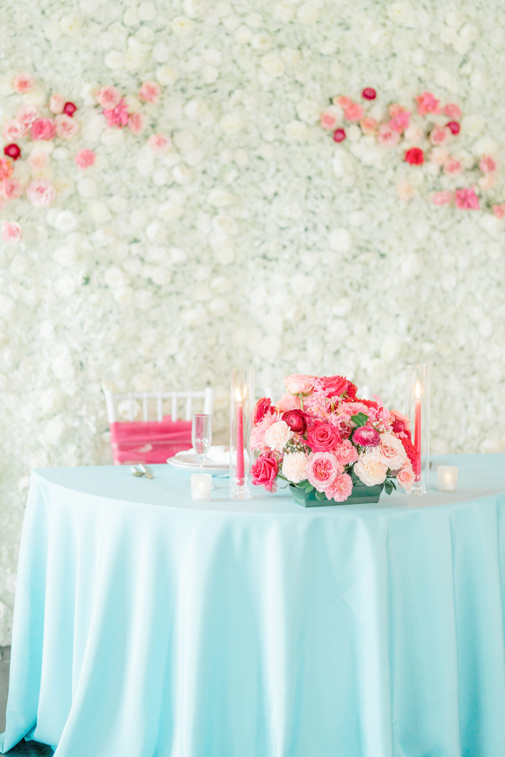 Whimsical Summer Inspired Wedding Decor, White Floral Wall Backdrop, Sweetheart Table with Turquoise Linen, Pink Candlesticks, Peach, Fuchsia Roses Floral Bouquet | Tampa Bay Wedding Rentals Gabro Event Services