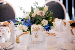 Classic Wedding Reception Decor, Gold and White Acrylic Table Numbers, Small Floral Centerpieces, White and Blush Pink Roses, Greenery Leaves, Blue Flowers | Tampa Bay Wedding Photographer Carrie Wildes Photography | Wedding Rentals Outside the Box Event Rentals | Wedding Planner Breezin' Weddings