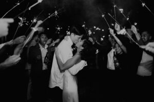 Bride and Groom Kiss During Sparkler Wedding Exit Wedding Portrait