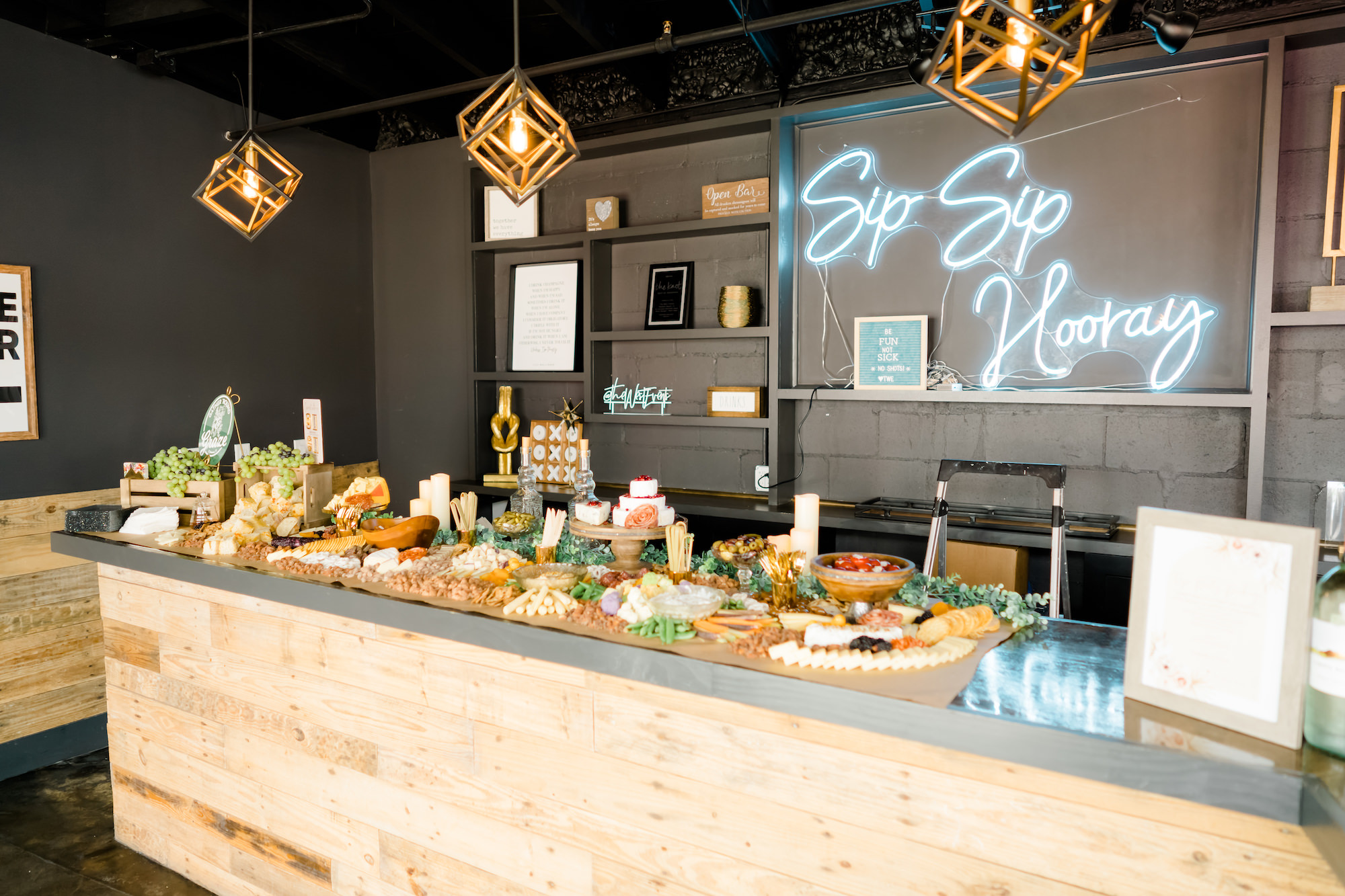 Wooden Bar with Charcuterie and White Neon Sign Backdrop | Madeira Beach Wedding Venue The West Events