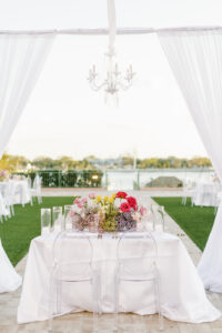 Outdoor Garden Sweetheart Reception Table with Ghost Chairs Chandelier and Romantic Drapery | Tampa Bay Rentals Gabro Event Services | Venue The Vinoy