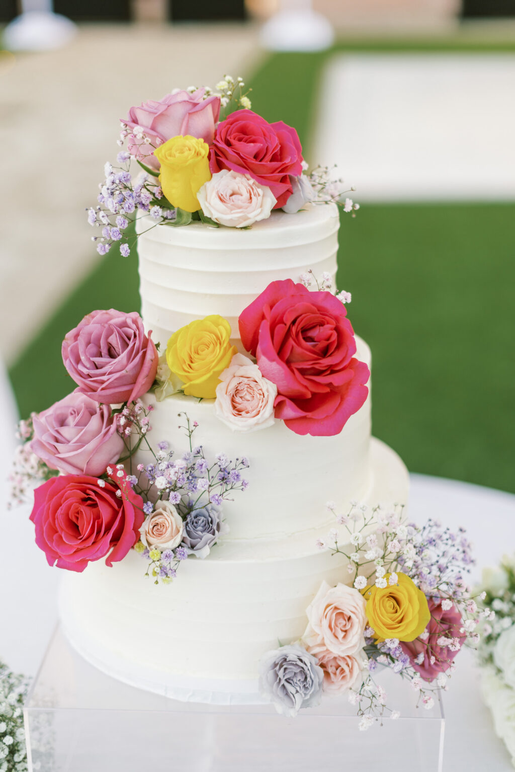 Three Tier Round White Wedding Cake With Fresh Red and Purple Roses and Baby's Breath | St. Pete Cake Baker The Artistic Whisk