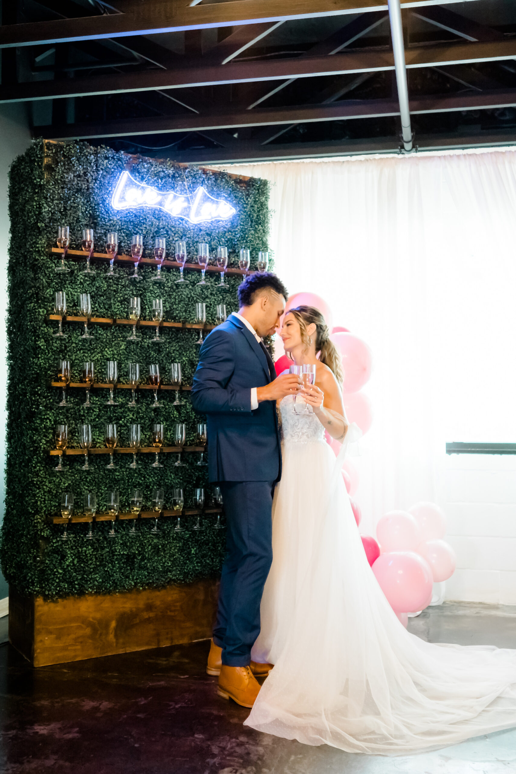 Greenery Panel Champagne Wall with White Neon Love is Love Sign | Tampa Bay Wedding Rentals Gabro Event Services | Venue The West Events
