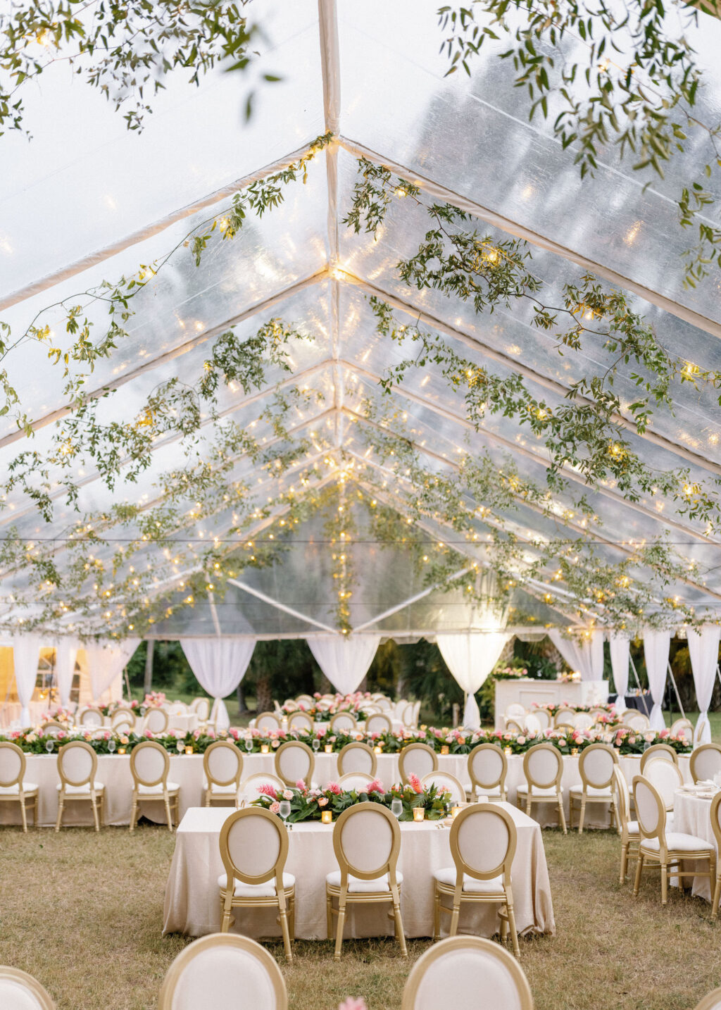 Luxurious Classic Outdoor Tent Wedding Reception Decor, Gold and Ivory Dining Chairs, Low Pink and Peach with Greenery Floral Bouquets, Hanging Greenery Garland, White Linens | Tampa Bay Wedding Venue Powel Crosley Estate | Tampa Bay Wedding Florist Botanica International Design Studio