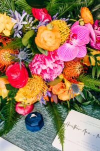 Vibrant Colorful Same Sex Wedding, Diamond Engagement Ring in Royal Blue Velvet Ring Box, Pink, Yellow, Red, and Purple Floral Bouquet