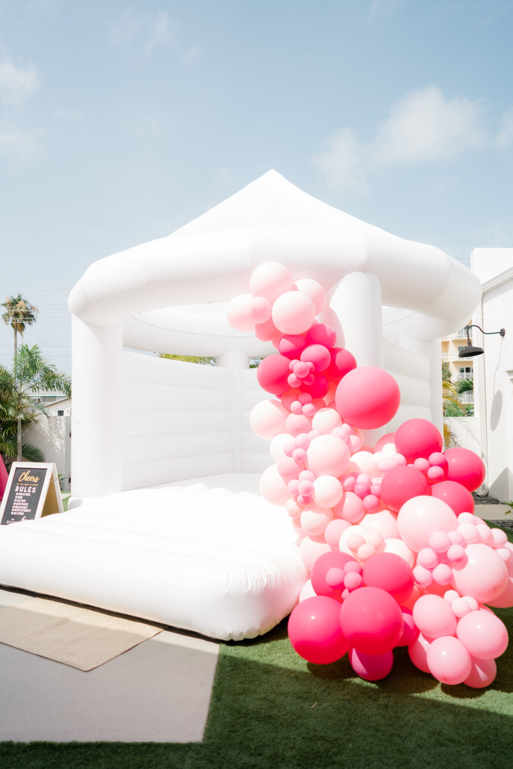 Whimsical Wedding Reception, White Bounce House with Pink Balloons