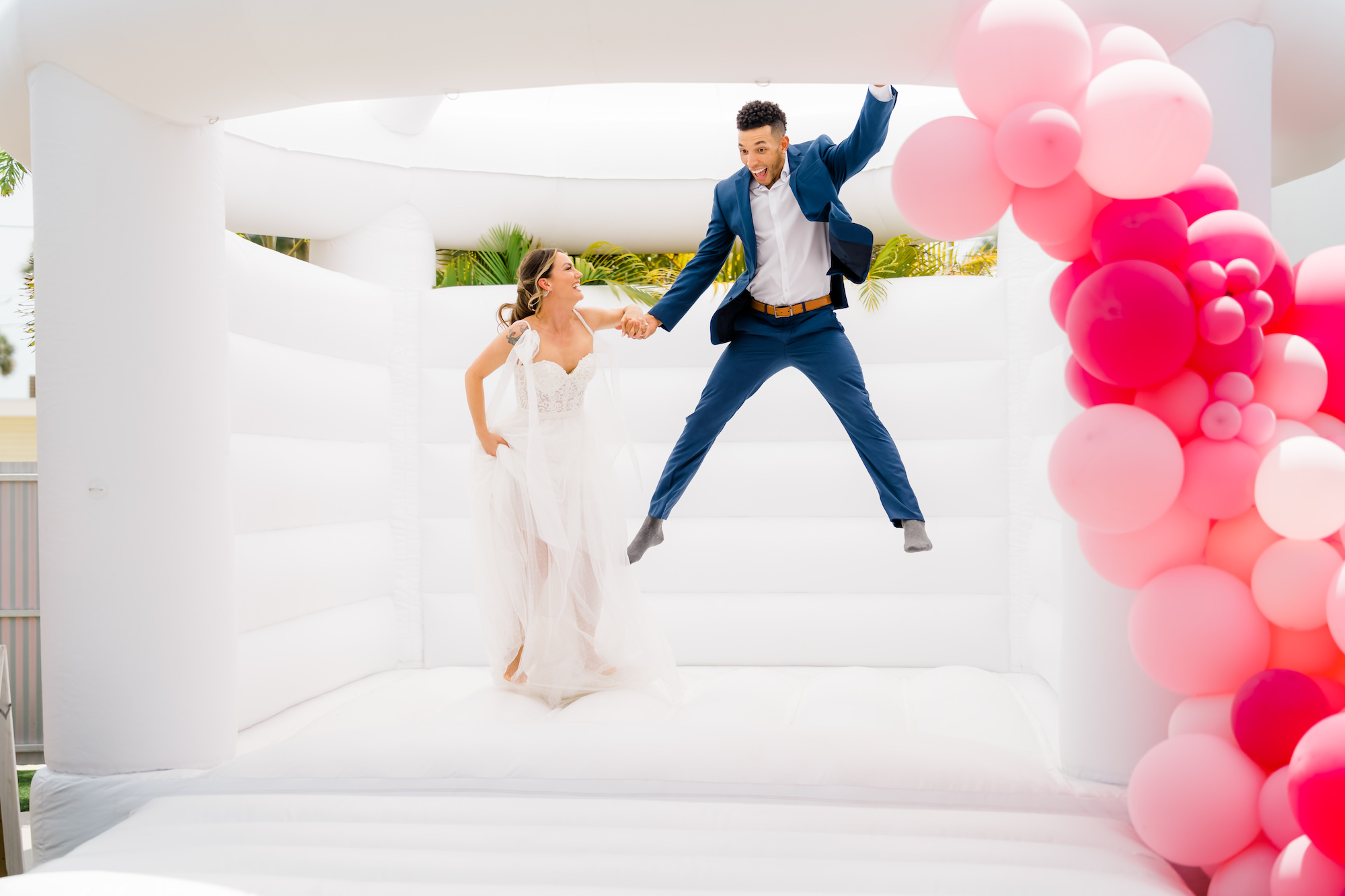 Whimsical Wedding Reception, White Bounce House with Pink Balloons