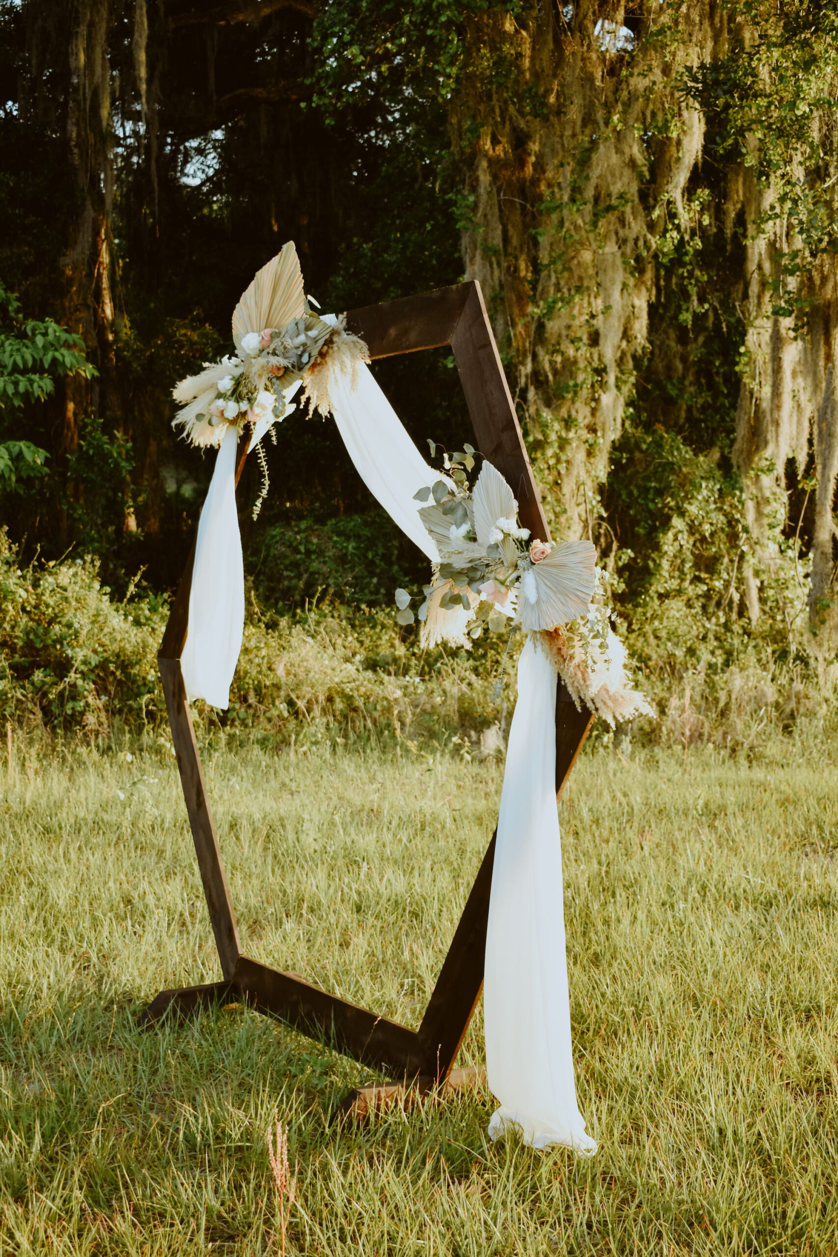 Octagon Wooden Ceremony Arch with White Draping and Dried Florals | Boho Wedding Ideas