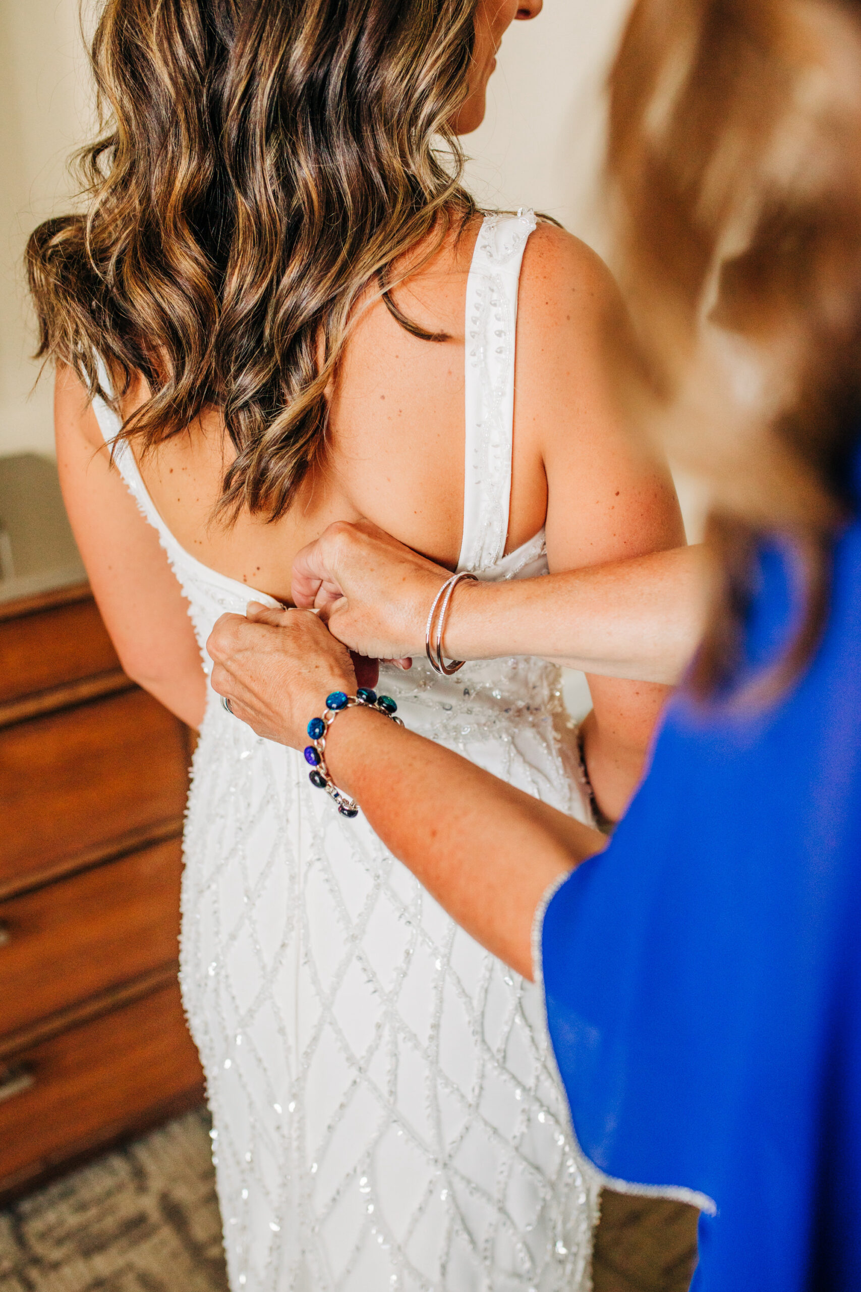Vibrant Colorful Same Sex Wedding, Bride Getting Wedding Ready Getting Dress Buttoned Up