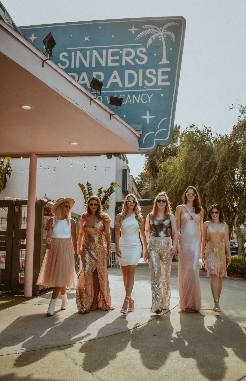 Bride and Bridesmaids in Mix and Match Gold and Blush Outfits at Bachelorette Party in Downtown St. Pete No Vacancy | Photographer The Gadabout Captures