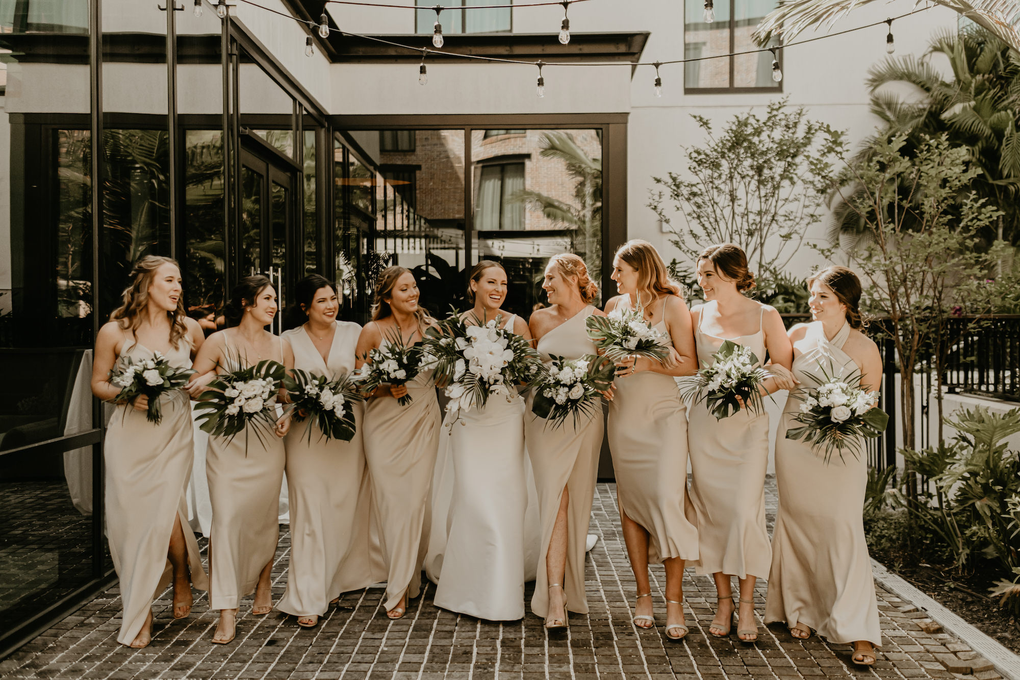 Mismatched Bridesmaids Neutral Champagne Wedding Dresses | Modern Tropical Bridal Party Wedding Inspiration | White Roses and Tropical Greenery Bouquets | Tampa Bay Florist Monarch Events and Design