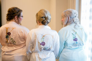 Bride, Maid of Honor, and Mother of the Bride in Matching Monogram Robes Getting Wedding Portrait | Tampa Bay Wedding Photographer Carrie Wildes Photography | St. Pete Wedding Hair and Makeup Adore Bridal