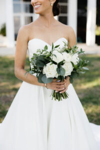 Classic Bride with Updo Wearing Strapless Sweetheart Neckline Wedding Dress Holding White Roses and Greenery Leaves Floral Bouquet | Tampa Bay Wedding Florist Monarch Events and Design