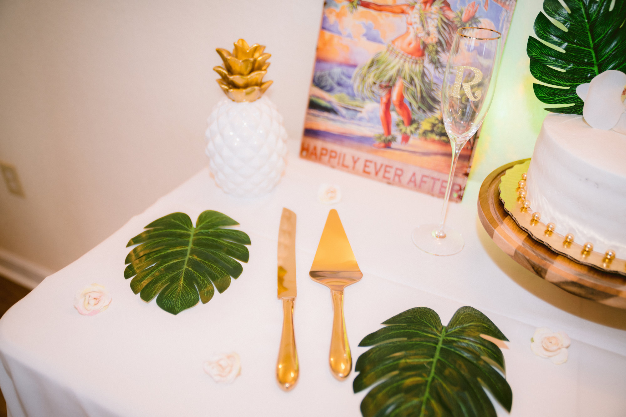 Tropical Wedding Cake Cutting Details with Gold Flatware and Monstera Leaves