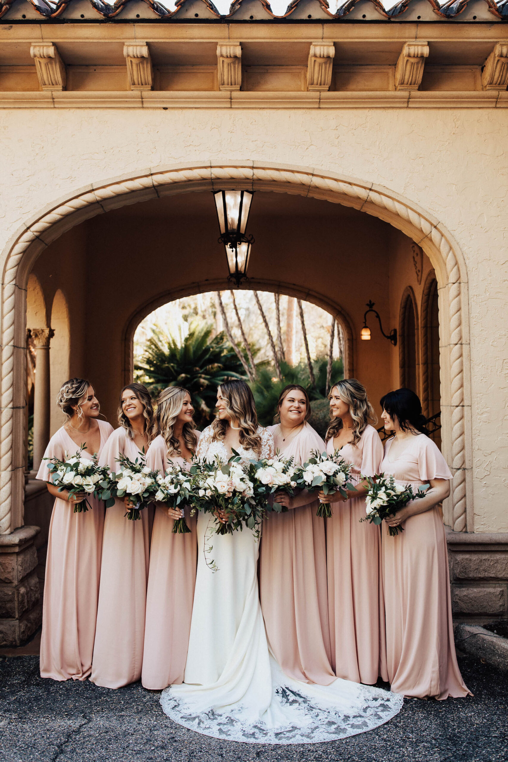 Bride and Bridesmaids in Blush Floor Length Wedding Dresses and White Floral Bouquets | Sarasota Hair and Makeup Artist Femme Akoi