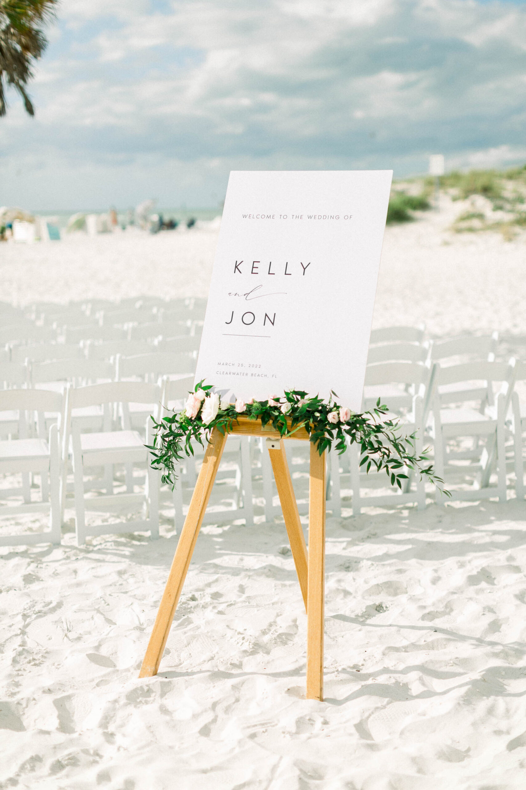 White Beach Wedding Ceremony Sign with Spring Floral Greenery Arrangement