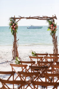 Driftwood Beach Wedding Ceremony Arch | Wood Crossback Chairs | Tropical Flower Arrangements Inspiration | St Pete Florist Save The Date Florida | Rentals Gabro Event Services