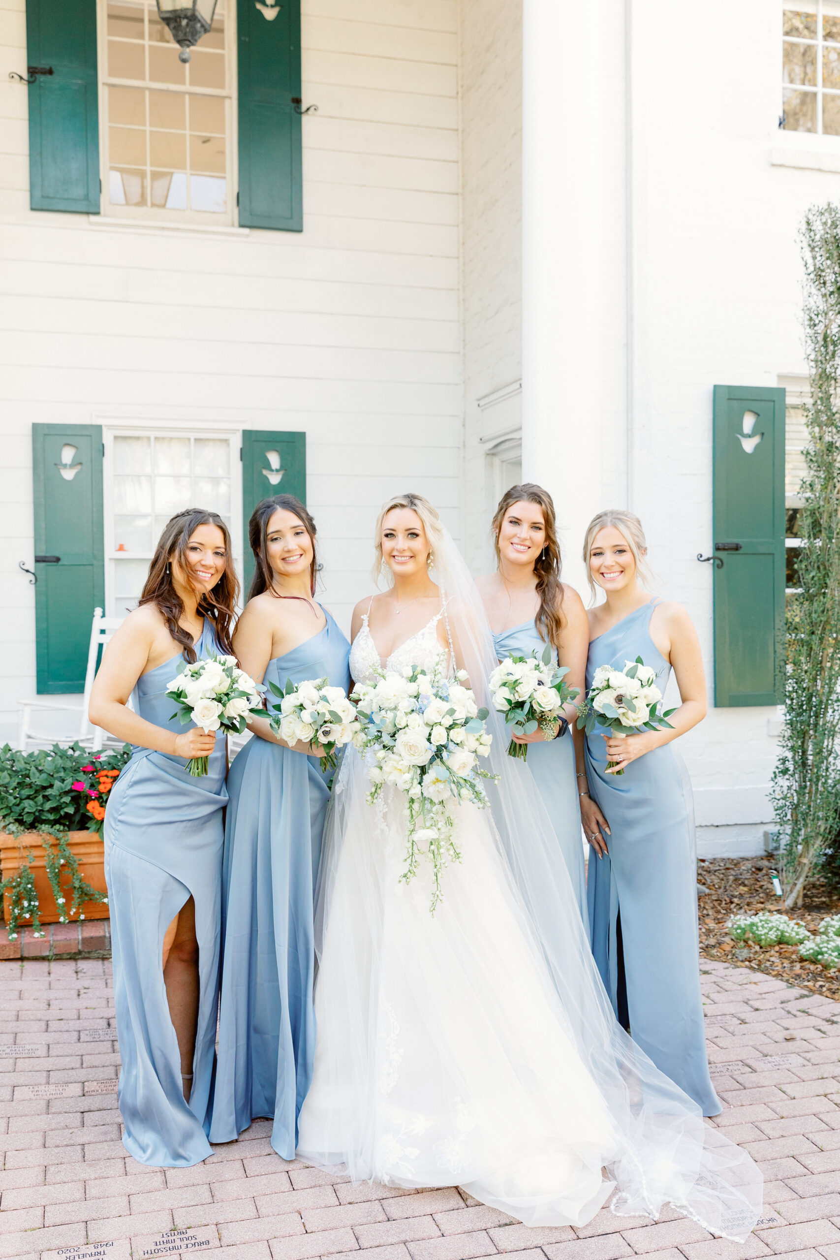 Bridal Party Attire Ideas for Spring Garden Wedding | Matching Dusty Blue Bridesmaids Wedding Dresses | White Rose and Blue Delphinium Bouquets | Sarasota Florist Botanica International Design Studio