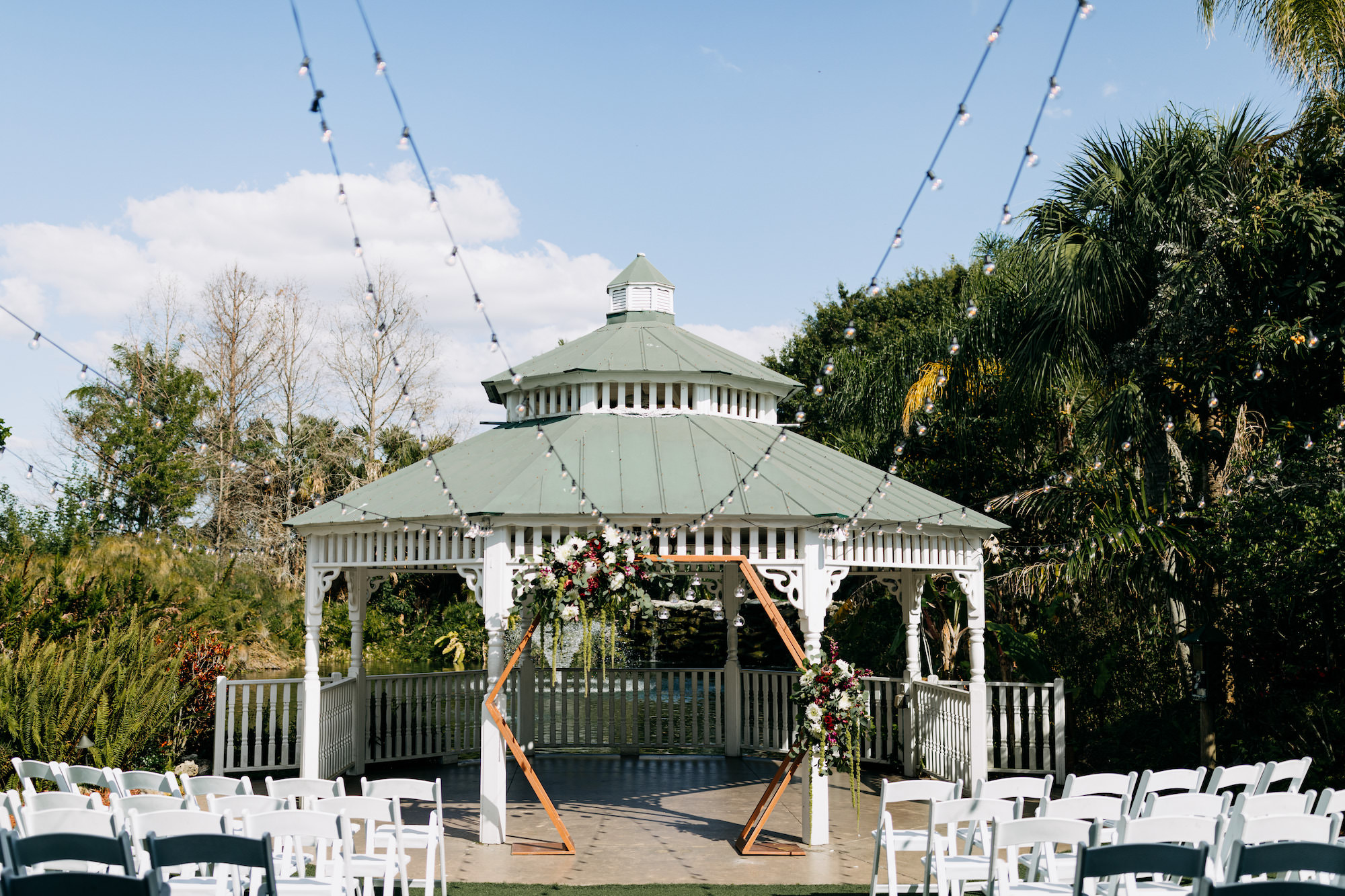 Outdoor Wedding Ceremony Gazebo with Geometric Hexagon Wooden Arch | Bohemian Flowers and Market Lights | Sarasota Wedding Venue The Pavilion at Mixon Farms