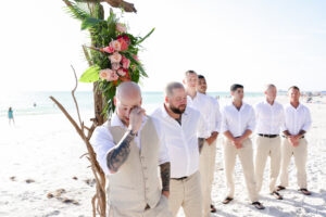 White and Khaki Groom and Groomsmen Beach Wedding Attire | Groom's Reaction to Bride Walking Down the Aisle