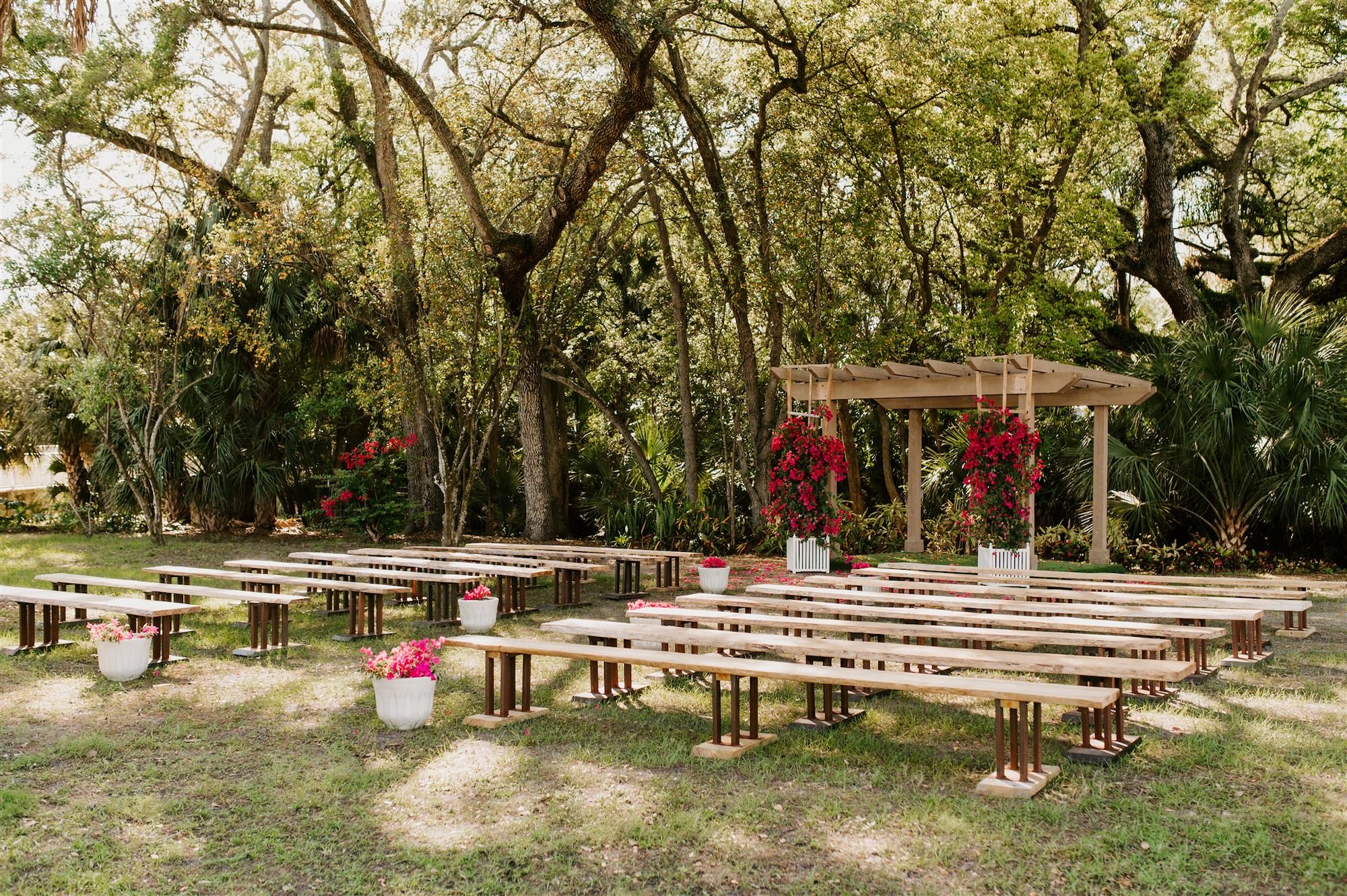 Outdoor Nature Inspired Ceremony Site Wood Benches Pergola Bold Pink Bouganvillea Flowers | Tampa Bay Wedding Venue Tabellas at Delaney Creek