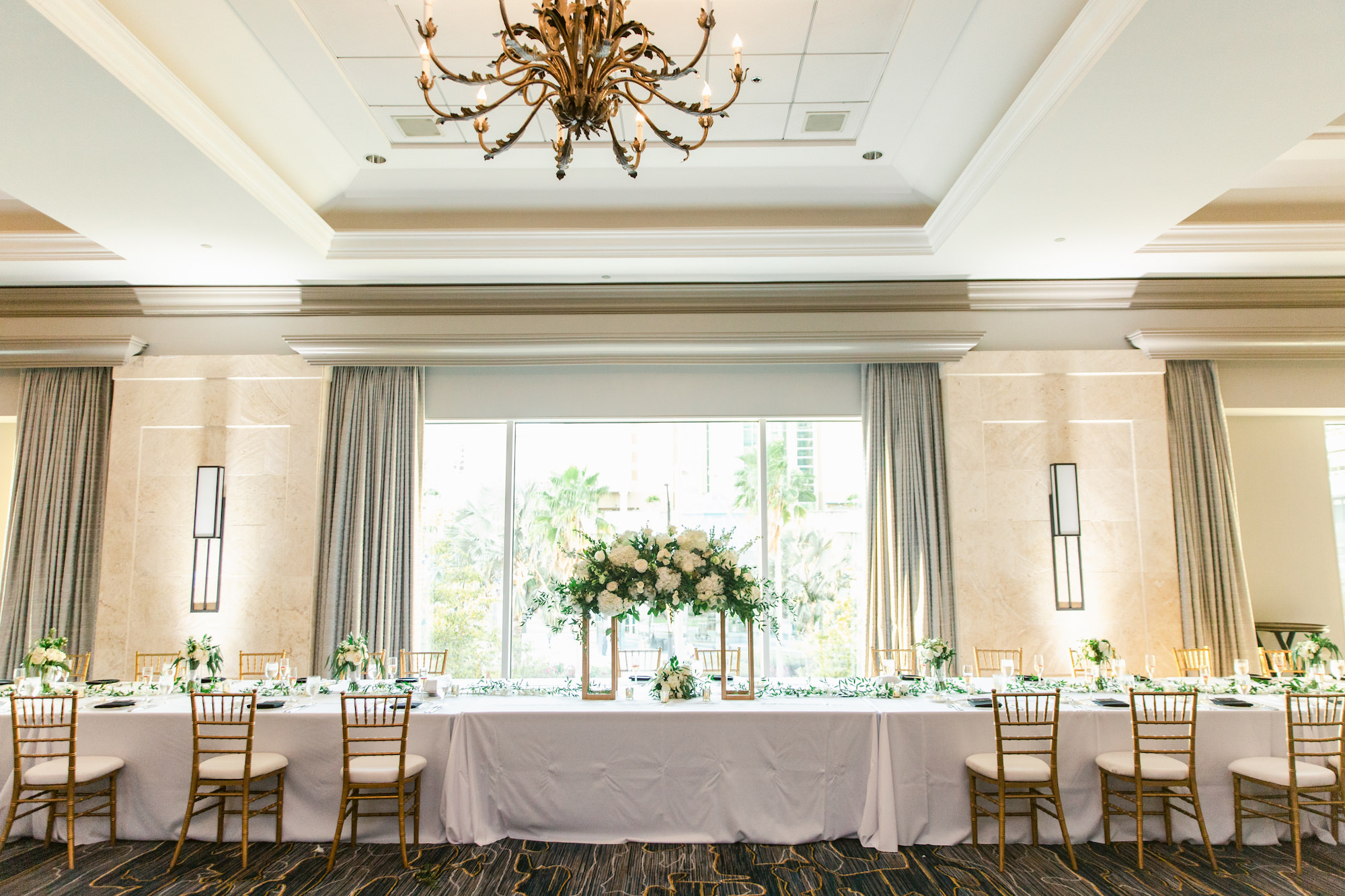 Classic Wedding Reception Decor, Head Table with Tall Floral Centerpieces, Greenery with White Flowers on Rectangular Stands, Chiavari Chairs | Tampa Bay Wedding Florist Save The Date | Kate Ryan Event Rentals | Planner EventFull Weddings