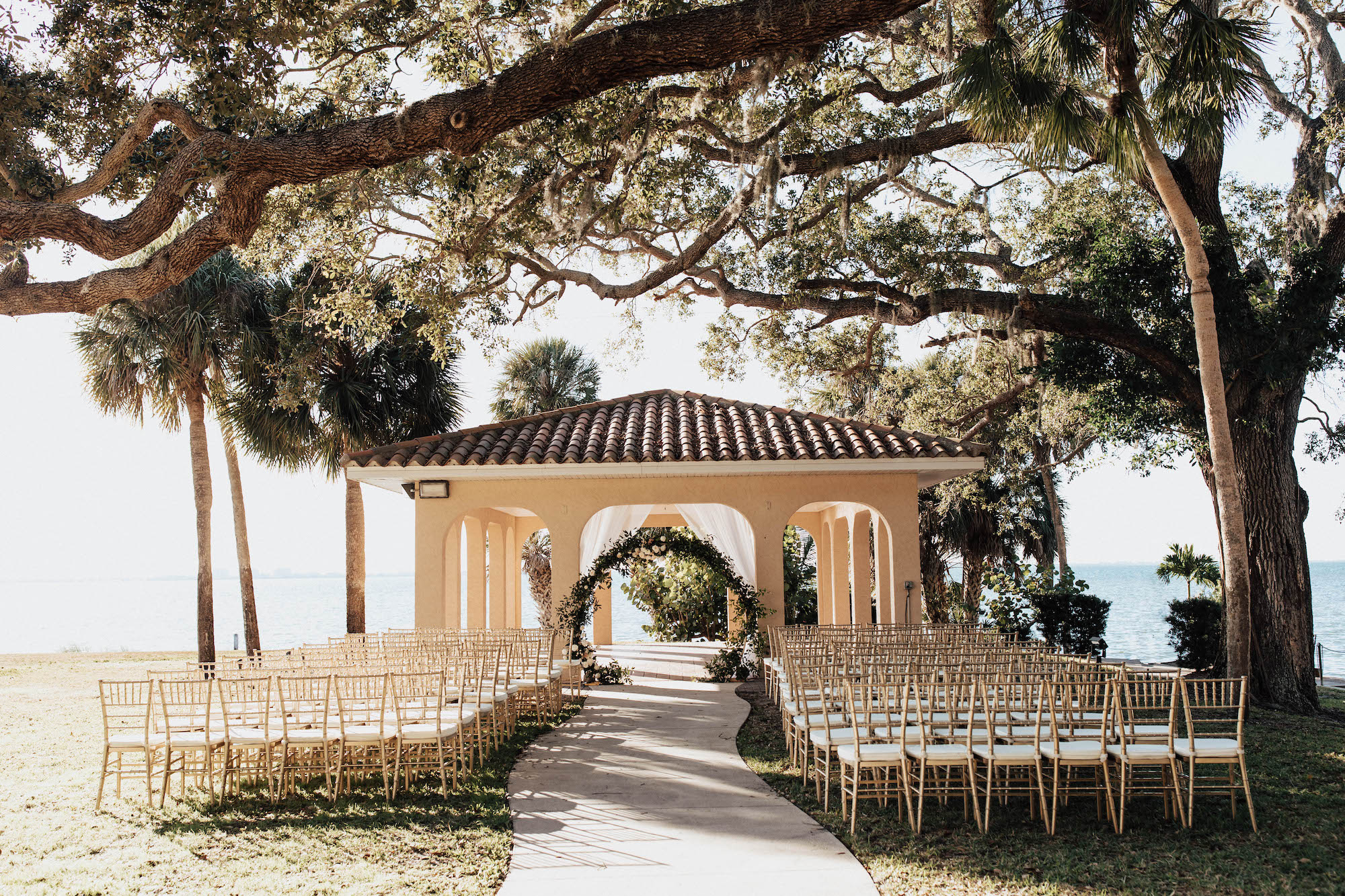 Classic Elegant Outdoor Wedding Ceremony with Circle Arch with Greenery Details | Sarasota Wedding Planner Taylored Affairs | Venue Powel Crosley