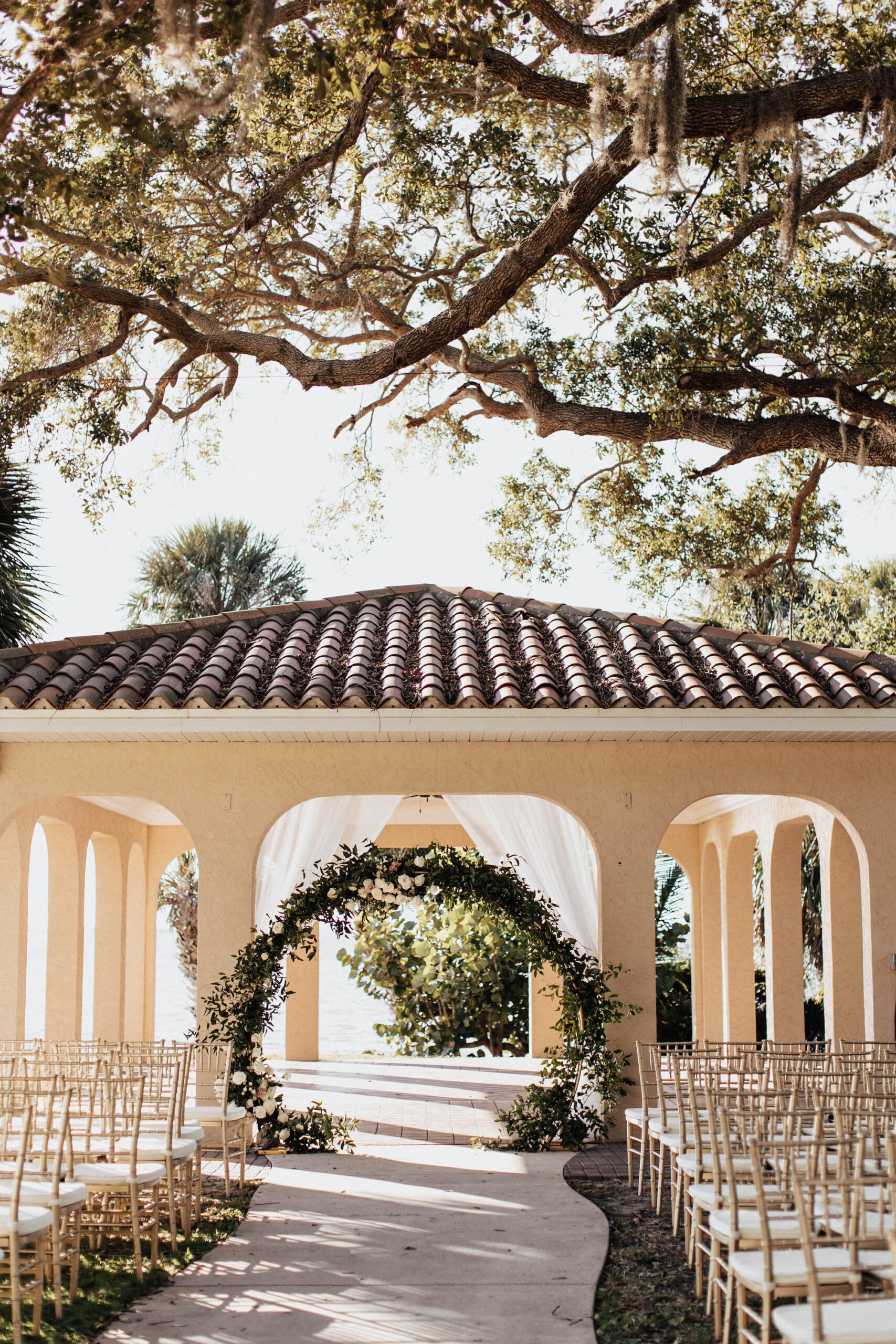 Classic Elegant Outdoor Wedding Ceremony with Circle Arch with Greenery Details