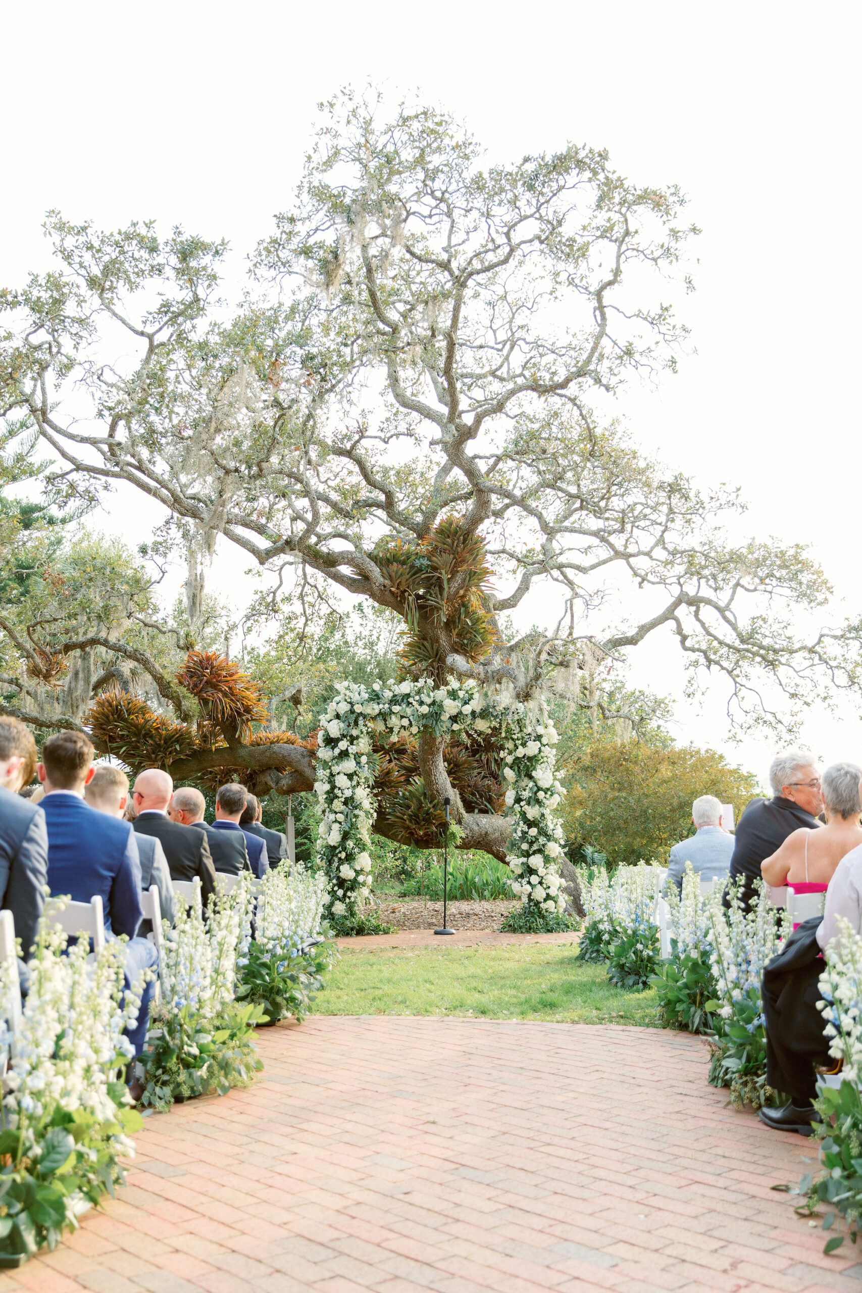 Outdoor Spring Wedding Ceremony Garden Inspiration | White and Greenery Floral Arch and Aisle Floral Arrangements | Sarasota Florist Botanica International Design Studio