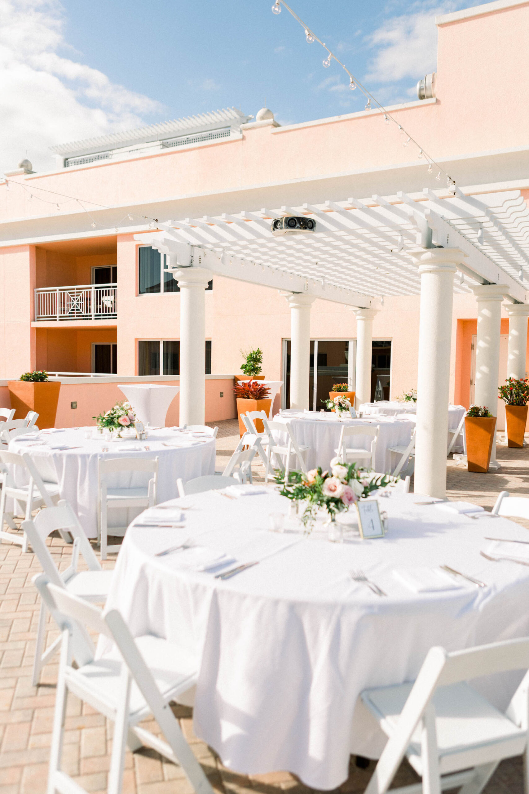 White Linens with Classic White Garden Chairs | Outdoor Destination Wedding Rooftop Reception Florida Wedding Venue Hyatt Regency Clearwater Beach