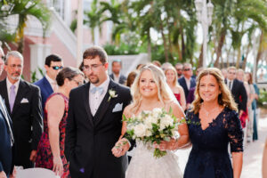 Bride Walking Down Wedding Ceremony Aisle with Mother and Father Portrait