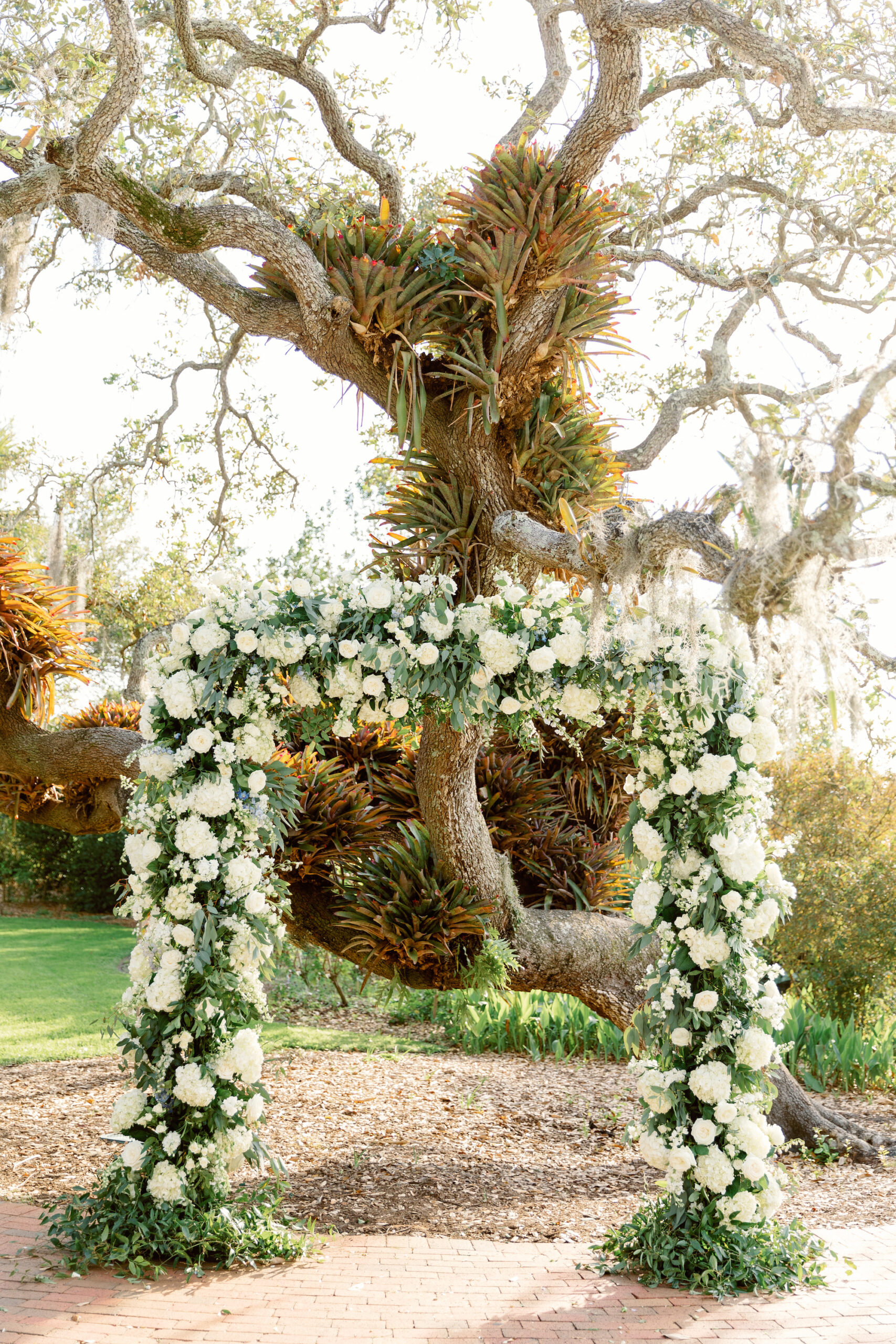 Outdoor Nature Inspired Spring Wedding Ceremony | White and Greenery Floral Arch | Sarasota Florist Botanica International Design Studio