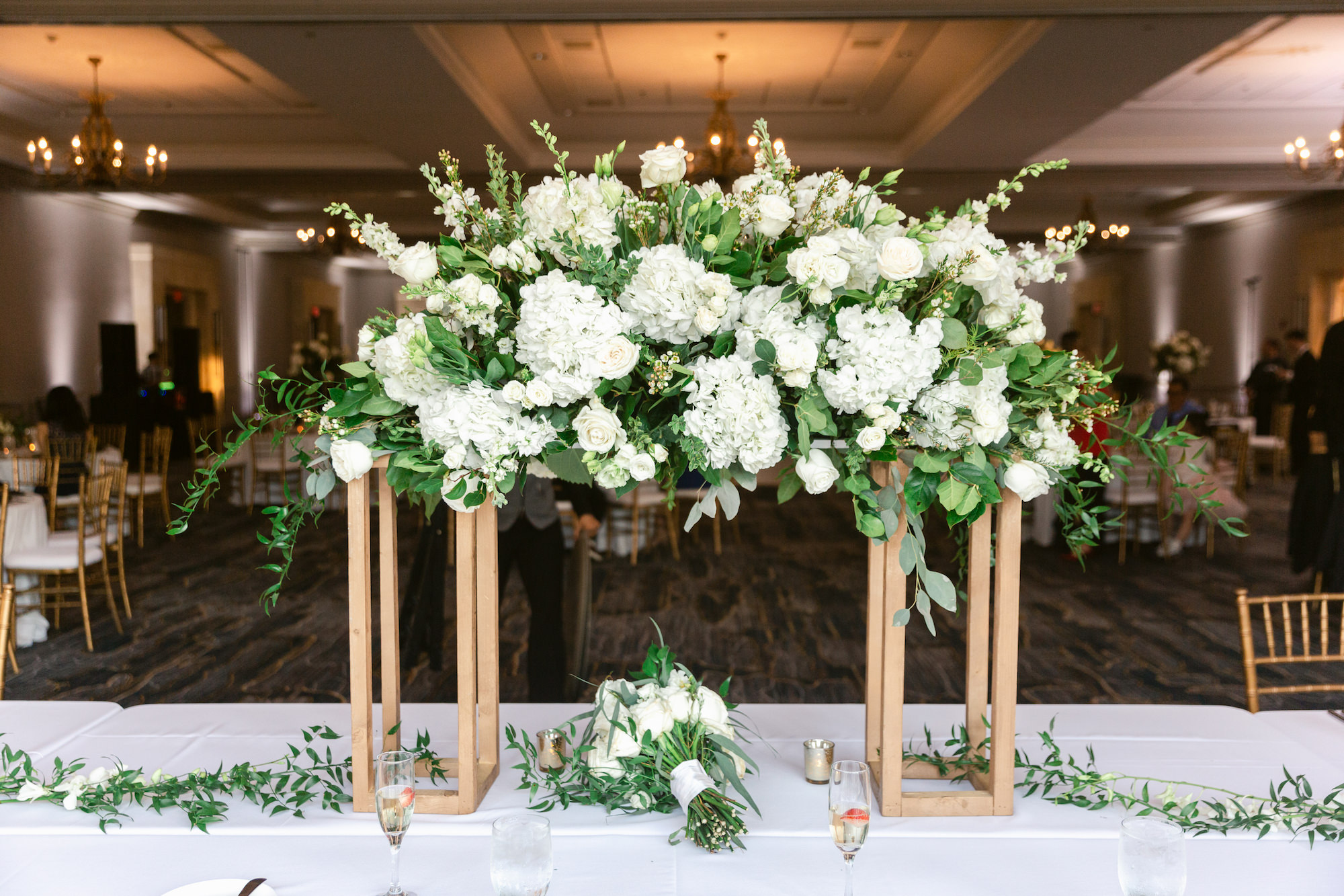 Classic Wedding Reception Floral Centerpiece for Head Table, Greenery with White Hydrangeas and Roses on Modern Gold Rectangular Stands | Tampa Bay Wedding Florist Save The Date