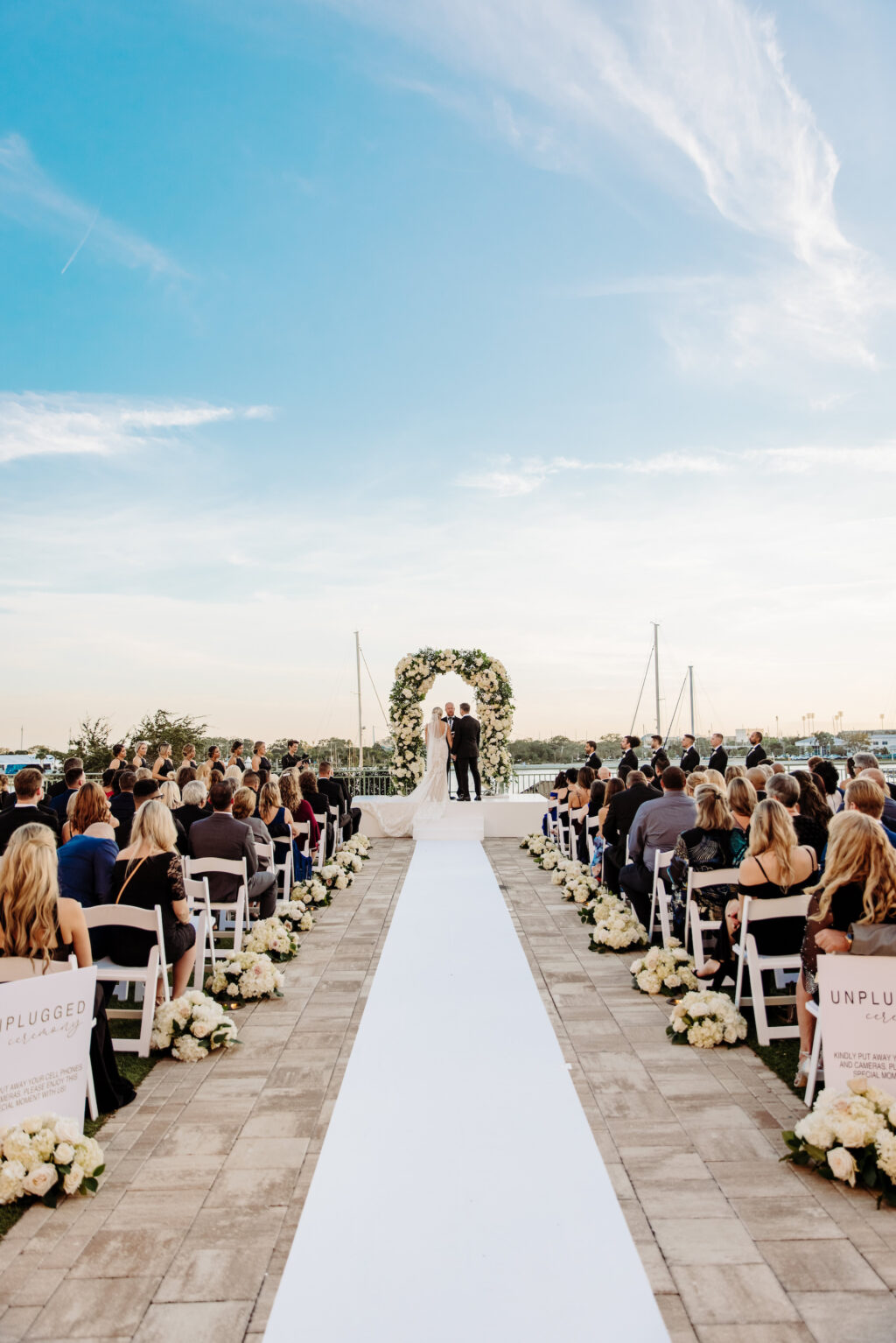 White Aisle Runner with Petite Rose and Hydrangea Flower Arrangement Decor Ideas | Outdoor Wedding Ceremony | Downtown St. Pete Venue Renaissance Vinoy