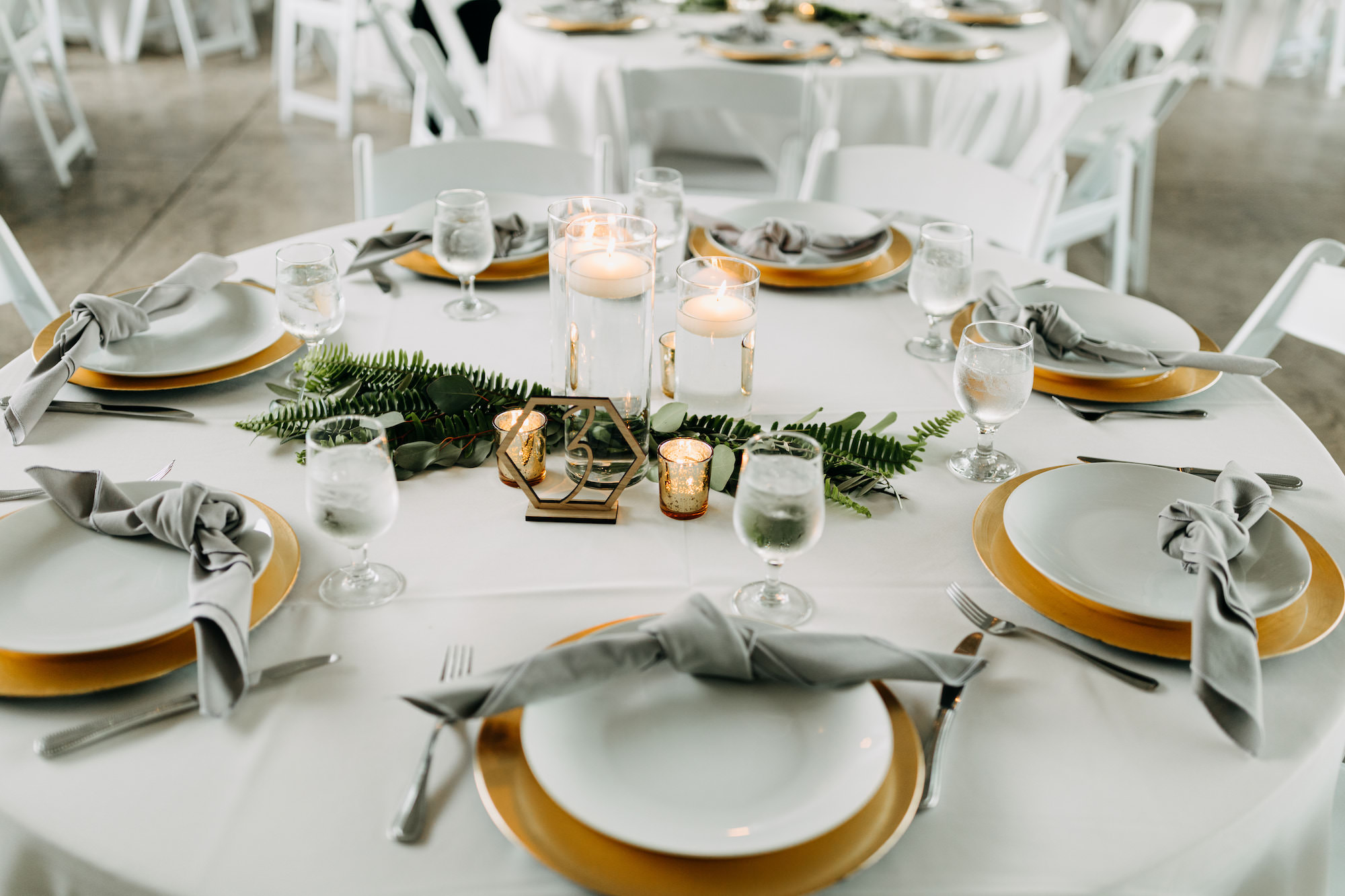 Greenery Centerpiece Inspiration | Gold Chargers with Gray Linens | Mercury Votives and Floating Candles