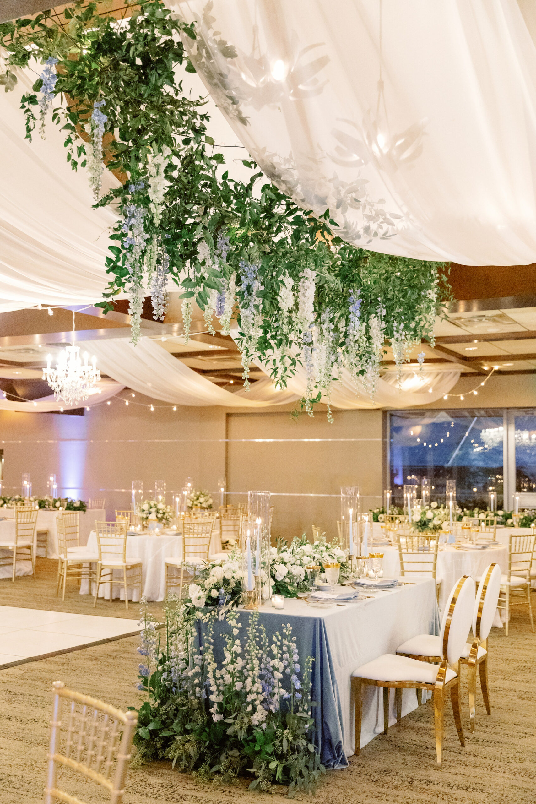 Reception Decor Ideas | Romantic Indoor White and Gold Spring Wedding Reception with Gold Chiavari Chairs and White Ceiling Drapery with Hanging Floral Arrangements and Garden Inspired Sweetheart Table | Sarasota Wedding Planner MDP Events | Florist Botanica International Design Studio | Venue Marie Selby Gardens